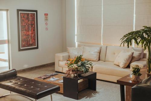 a living room with a couch and a table at Hotel BR 364 in Cacoal