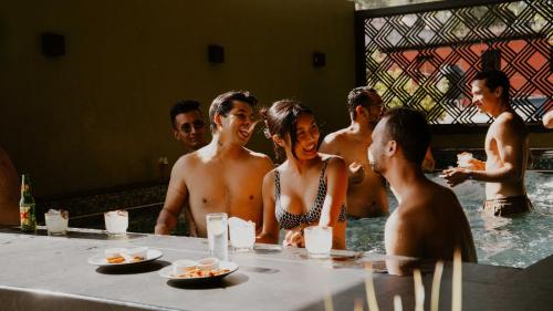 a group of people standing in a swimming pool at Viajero Oaxaca Hostel in Oaxaca City