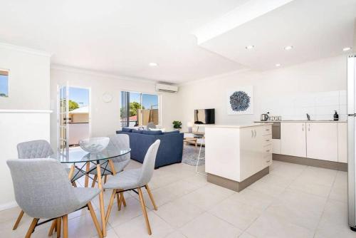 a kitchen and living room with a glass table and chairs at Modern Midland Retreat 2br 1 Bth in Midland Junction