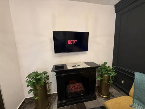 a living room with a tv above a fireplace at Loft Paris en ValQuirico in Santeagueda