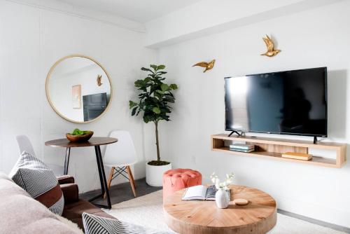 a living room with a tv and a table at THE MANDO, walkable to PonceCityMarket in Atlanta