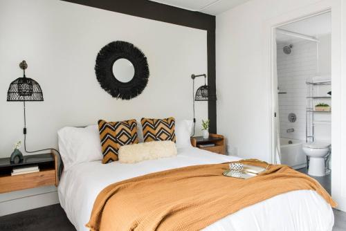 a bedroom with a bed and a mirror on the wall at THE MANDO, walkable to PonceCityMarket in Atlanta