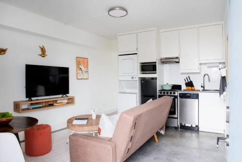 a living room with a couch and a table at THE MANDO, walkable to PonceCityMarket in Atlanta