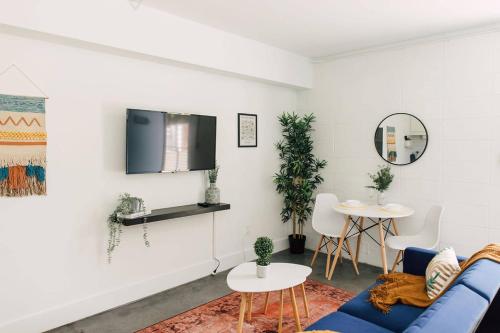 a living room with a blue couch and a table at *NEW* - The Coretta: Downtown | Walkable | Rooftop in Atlanta