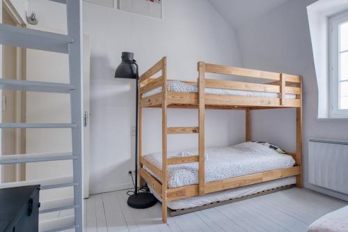 a bunk bed in a room with a ladder at Maison typique Trouville, idéale famille in Trouville-sur-Mer