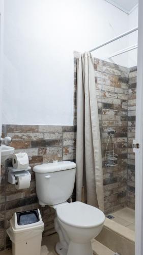 a bathroom with a toilet and a shower at Casa Caribe in Talamanca