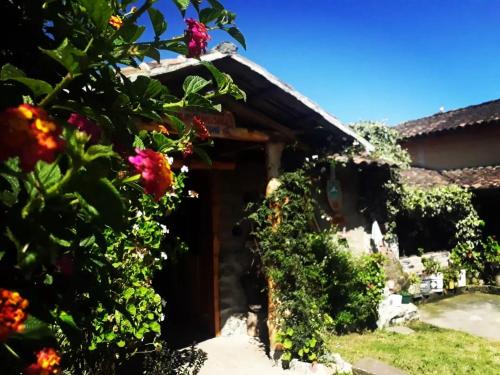 a house with flowers in front of it at Karanki Indigenous in Ibarra
