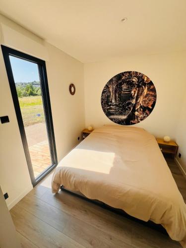 a bedroom with a bed and a large window at Buddha Cottage - PMR in Rosselange
