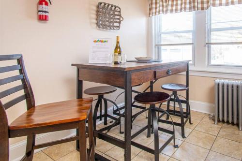 a kitchen with a bar with stools and a bottle of wine at Restaurants Coffee Colleges Bryn Mawr Has It All in Bryn Mawr
