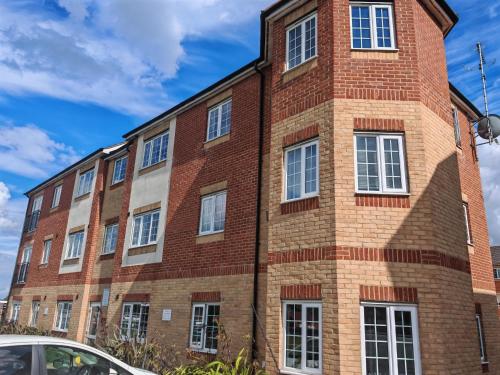a red brick building with white windows at 2 bed Flat near Corby Town Centre in Corby