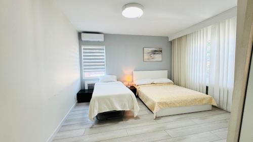 two beds in a room with white walls at Line&Light 
