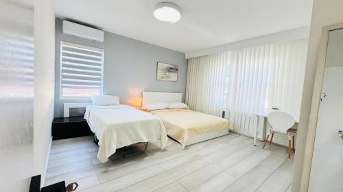 a bedroom with two beds and a table and chairs at Line&Light 