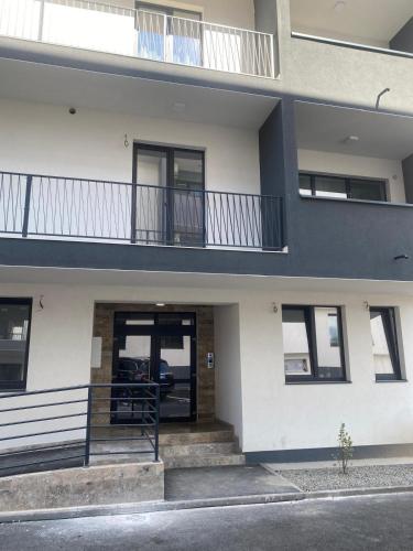 an apartment building with a balcony and a door at Studio Felix Relax MAO 13&14 in Baile Felix