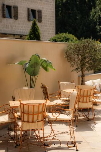 a group of chairs and tables on a patio at Adiya Signature Hotel - Adults only in Kotor