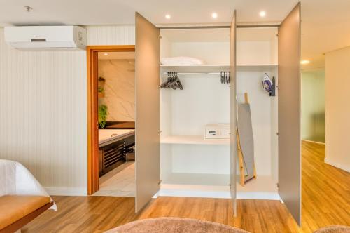 a bedroom with a sliding door leading to a room with a bed at Holiday Inn - Goiania by IHG in Goiânia