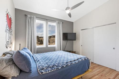 a bedroom with a bed and a large window at Mid-century Modern Escape Hikingbiking Nearby! in Salida