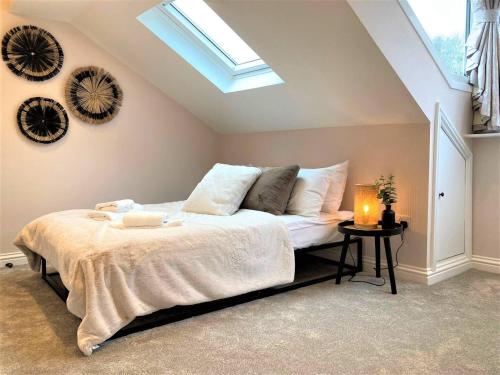 a bedroom with a large bed with a skylight at Escape 2 Unwind, Minster Retreat - Sleeps 5 in York