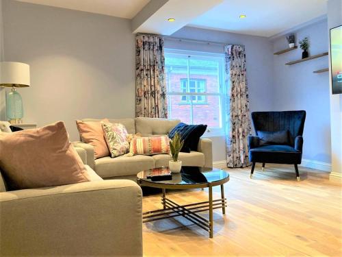 a living room with a couch and a table and a chair at Escape 2 Unwind, Minster Retreat - Sleeps 5 in York