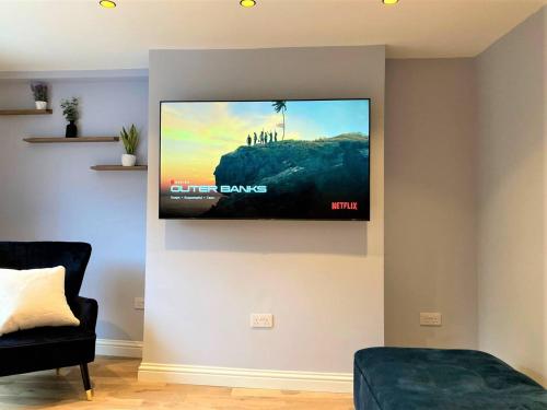 a flat screen tv hanging on a wall in a living room at Escape 2 Unwind, Minster Retreat - Sleeps 5 in York