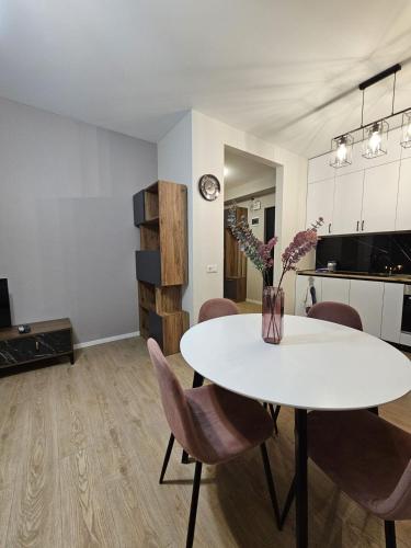 a living room with a white table and chairs at Apartment for daily rent in Tbilisi City