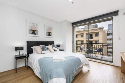 a bedroom with a large bed and a large window at 504 - Perth Cbd Huge 1br 1ba Beauty in Perth