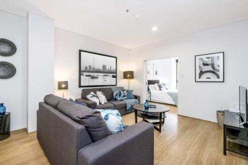 a living room with a couch and a table at 504 - Perth CBD Huge 1BR 1BA Beauty in Perth