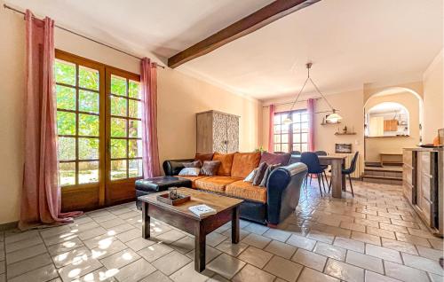 a living room with a couch and a table at Villa Proche Cévennes in Saint-Hilaire-de-Brethmas