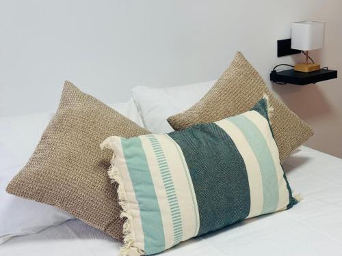 a pile of pillows sitting on top of a bed at Sunset in Guadalest in El Castell de Guadalest