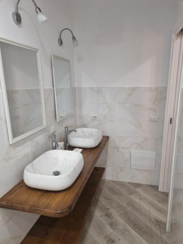 a bathroom with two sinks on a wooden counter at Il borgo in Vico Equense