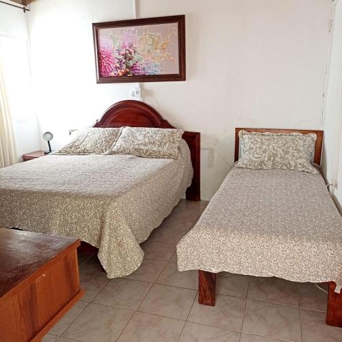 Postel nebo postele na pokoji v ubytování Hostal CORALES