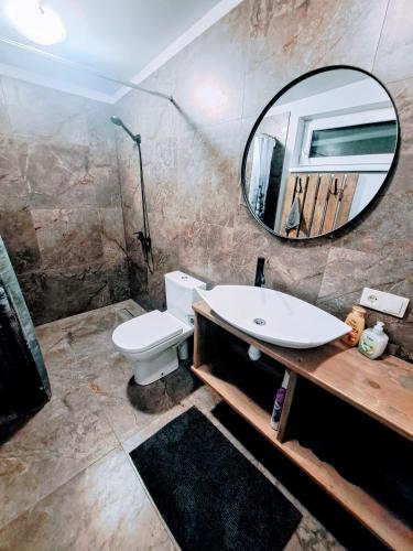 a bathroom with a sink and a mirror at Guest House Podnieki in Ventspils