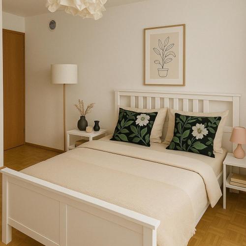 a bedroom with a white bed with green pillows at Casa al Sasso in Bellinzona