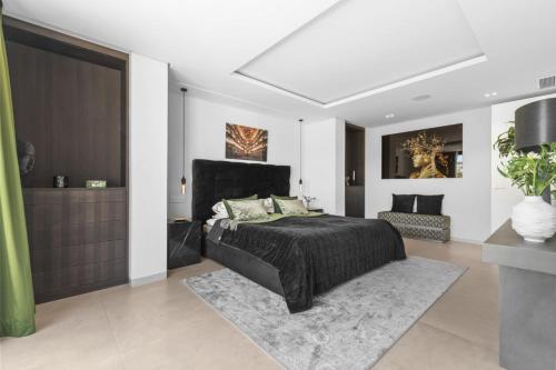 a bedroom with a bed with a black headboard at Sunset Villa With Pool in Bodrum City