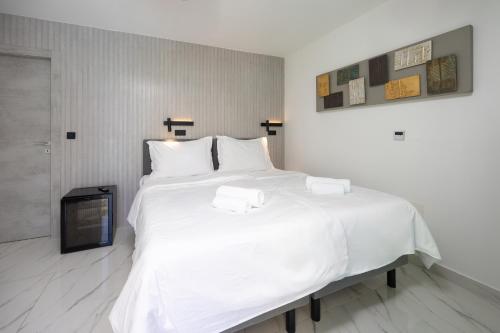a large white bed with two white towels on it at Hotel - Teranea City Hvar in Hvar