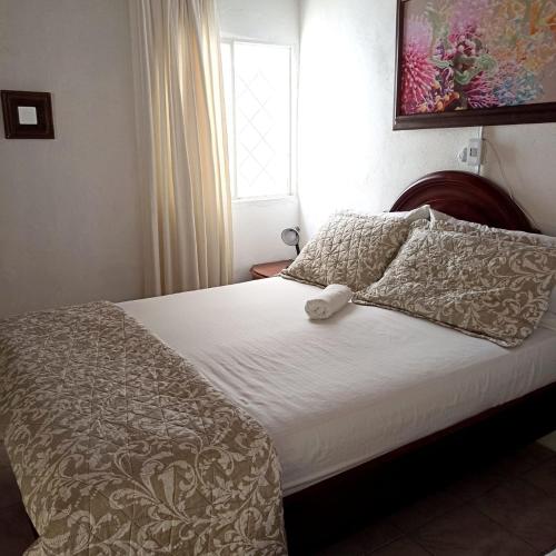 Postel nebo postele na pokoji v ubytování Hostal CORALES