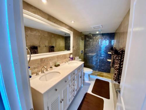 a bathroom with a sink and a toilet and a mirror at Look No Further!!! Amazing Condo in Fort Lauderdale