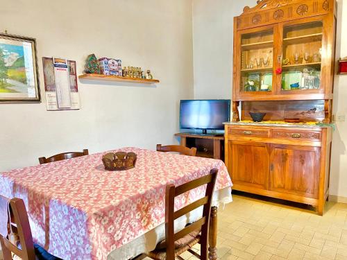 a dining room with a table and a tv at Casa di Nonna in Montefranco