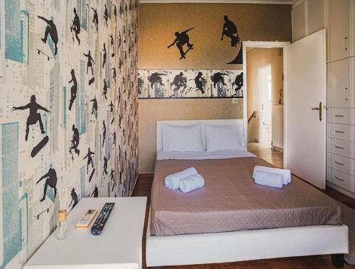 a bedroom with a bed with two towels on it at Villa Kazantzaki in Athens