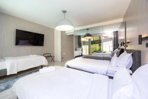 a hotel room with two beds and a tv at Hotel - Teranea City Hvar in Hvar