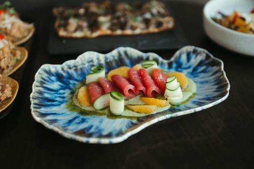 a plate of food with hot dogs and fruit at San Francisco Marriott Marquis Union Square in San Francisco