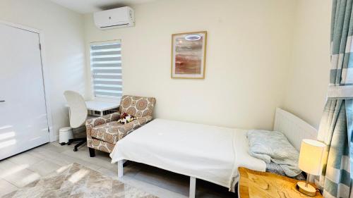 a hospital room with a bed and a chair at Fancy private home 