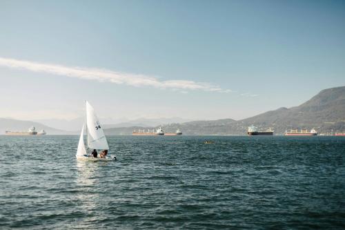 a small sail boat in a large body of water at Delta Hotels by Marriott Vancouver Downtown Suites in Vancouver