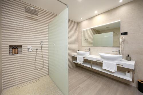 a bathroom with two sinks and a mirror at Hotel - Teranea City Hvar in Hvar
