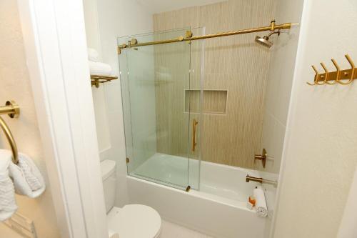 a bathroom with a glass shower with a toilet at D313 - Sea Blue in Oceanside