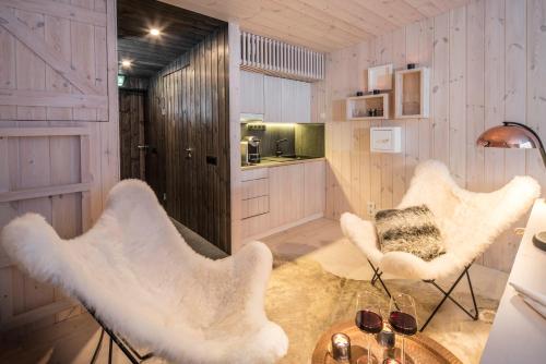 a living room with a couch and a chair at Arctic TreeHouse Hotel in Rovaniemi