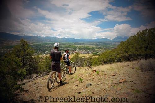 two people riding bikes on a hill overlooking a valley at Riverfront Condo With Balcony, King Bed Str#267 in Salida