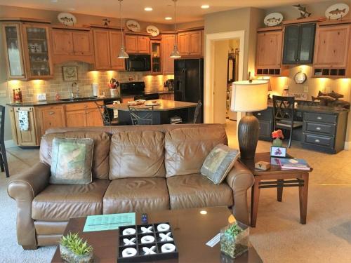 a living room with a brown couch and a kitchen at Riverfront Condo With Balcony, King Bed Str#267 in Salida