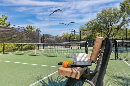 a bench on a tennis court with a tennis racket at Marriott's Harbour Point and Sunset Pointe at Shelter Cove in Hilton Head Island
