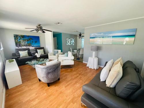 a living room with a couch and a table at Cozy Pool-House with 3 bedrooms-2 bathrooms in Margate