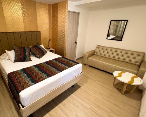 a hotel room with a bed and a couch at Casa Turística Don Juan in Ibagué